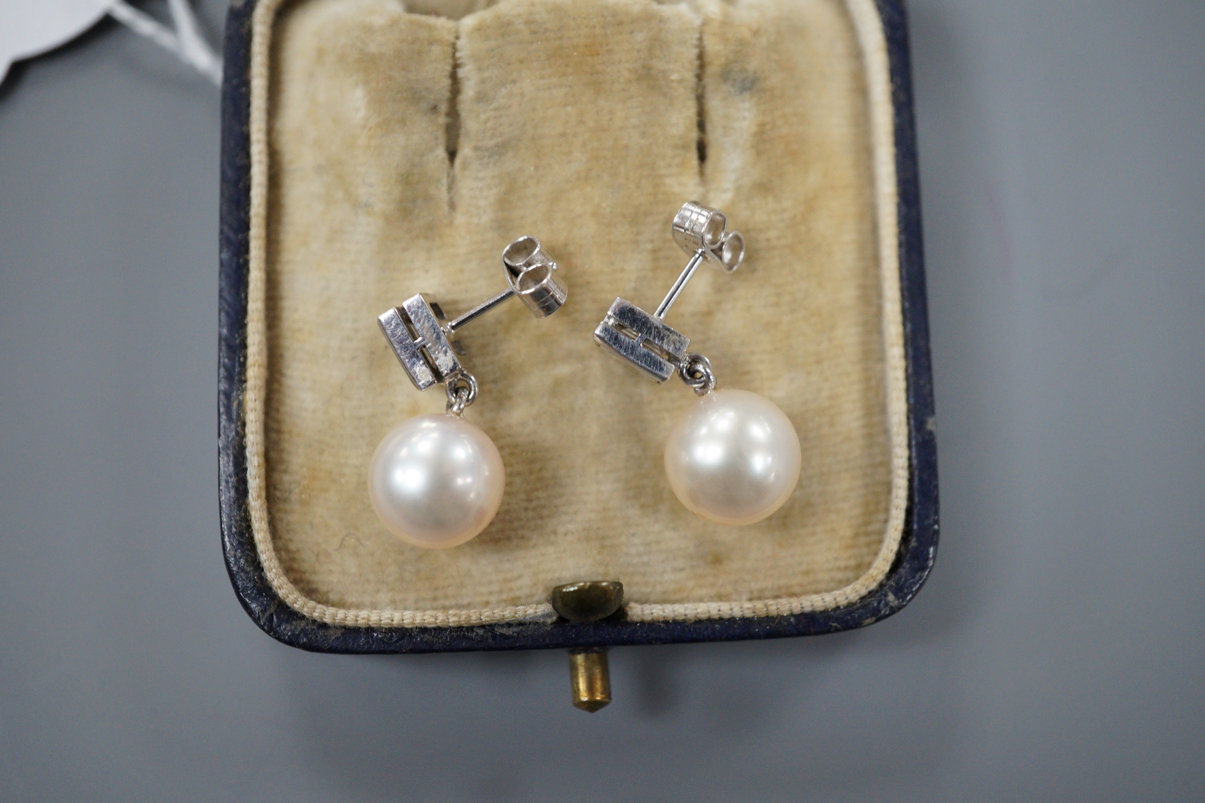 A pair of 18ct white metal, cultured pearl and diamond set drop earrings, 17mm, gross weight 4.3 grams.